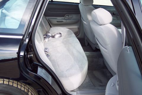2001 Ford Crown Victoria - The interior of a 2001 Ford Crown Victoria shows light grey cloth seats and door panels.