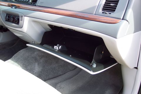 2001 Ford Crown Victoria - The interior of a 2001 Ford Crown Victoria is visible, with the glove compartment open.