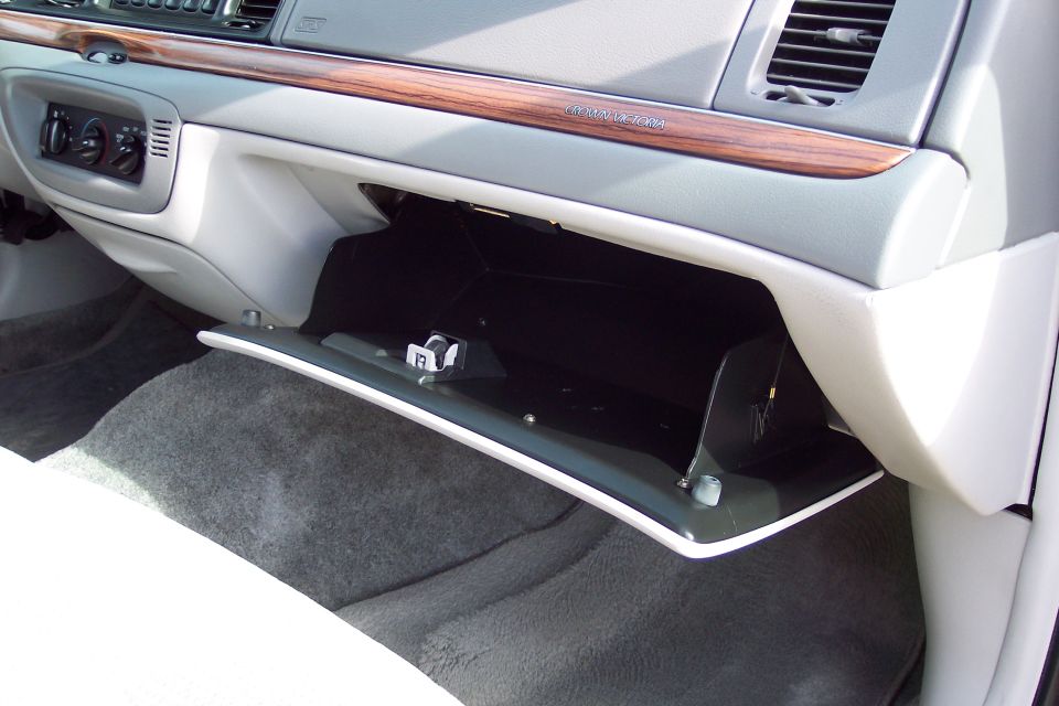 Interior of a 2001 Ford Crown Victoria showing an open glove box and wood trim