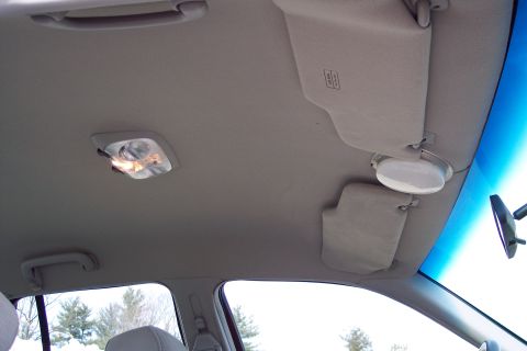 2001 Ford Crown Victoria - Interior view of a car's ceiling, showing the sun visors and dome light.