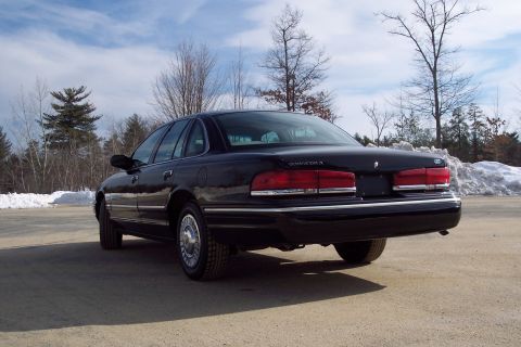 2001 Ford Crown Victoria - A black 2001 Ford Crown Victoria is parked outdoors with snow on the ground.