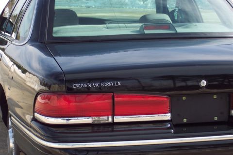 2001 Ford Crown Victoria - Black 2001 Ford Crown Victoria LX rear view showing taillights and trunk lid badge.