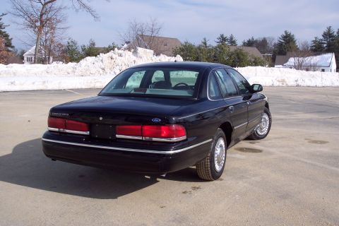 2001 Ford Crown Victoria - Rear view of a black 2001 Ford Crown Victoria sedan parked outdoors in winter.
