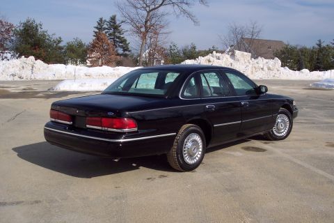 2001 Ford Crown Victoria - This black 2001 Ford Crown Victoria sedan is shown from the rear three-quarter angle.