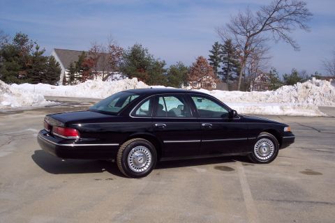 2001 Ford Crown Victoria - Side view of a black 2001 Ford Crown Victoria parked outdoors in winter.