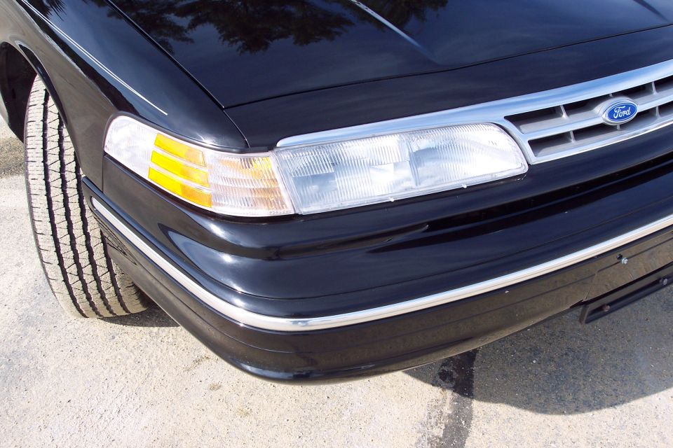 Black 2001 Ford Crown Victoria front corner with chrome grille and headlights