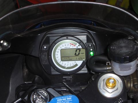 1988 Ford Bronco - Close-up of a motorcycle's digital dashboard displaying speed and mileage.