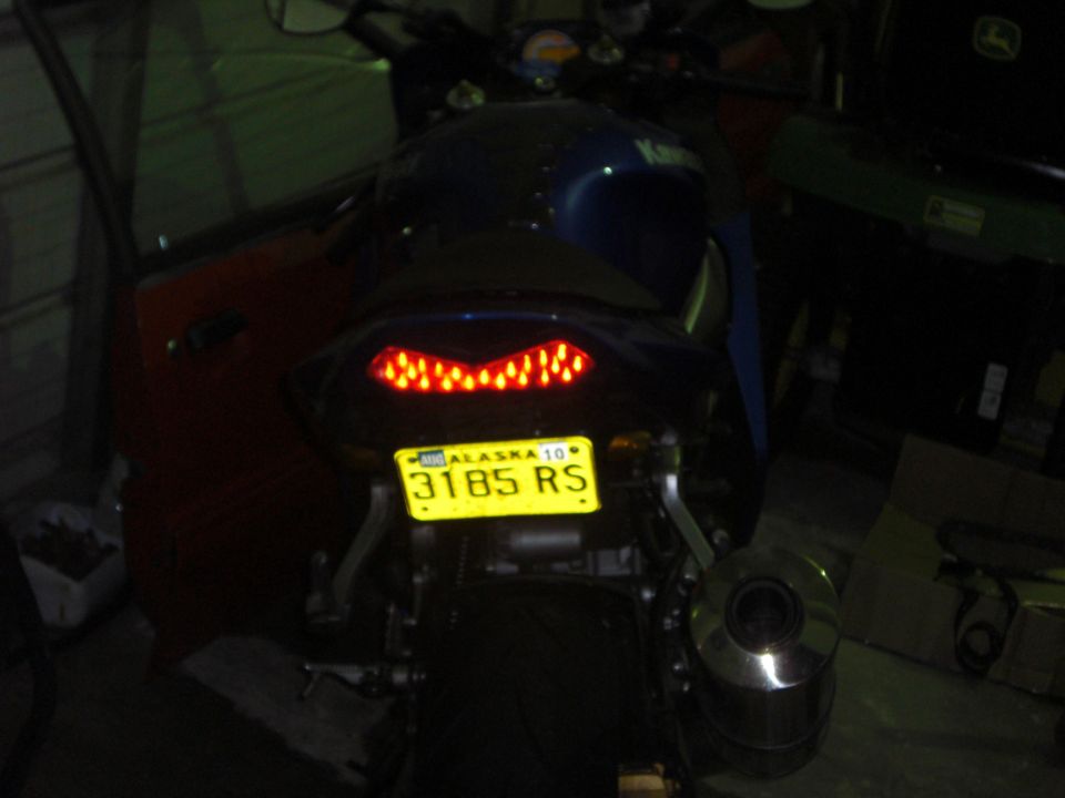 Motorcycle tail light and yellow Alaska license plate 3185 RS
