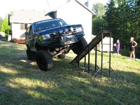 1991 Ford Bronco - A black 1991 Ford Bronco is positioned on an RTI ramp, with a club sticker visible on the windshield.