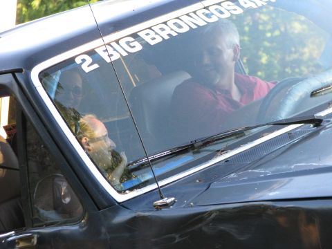 1991 Ford Bronco - The driver and passenger are visible through the windshield of a vehicle with text on the glass.