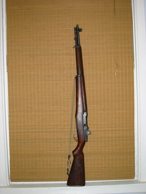 1996 Ford Bronco - An M1 Garand rifle is shown against a textured background.