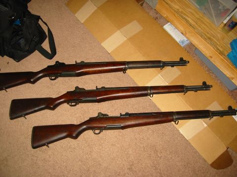 1996 Ford Bronco - Three M1 Garand rifles are displayed on a carpeted surface, with cardboard boxes in the background.