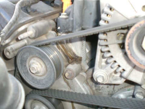 2000 Mercury Grand Marquis - Engine belt tensioner and pulleys showing a fluid leak.