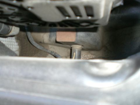 2000 Mercury Grand Marquis - A close-up view of an engine component, showing wiring and metal parts.