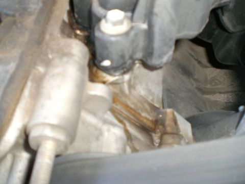 2000 Mercury Grand Marquis - Close-up of an engine part showing a fluid leak.