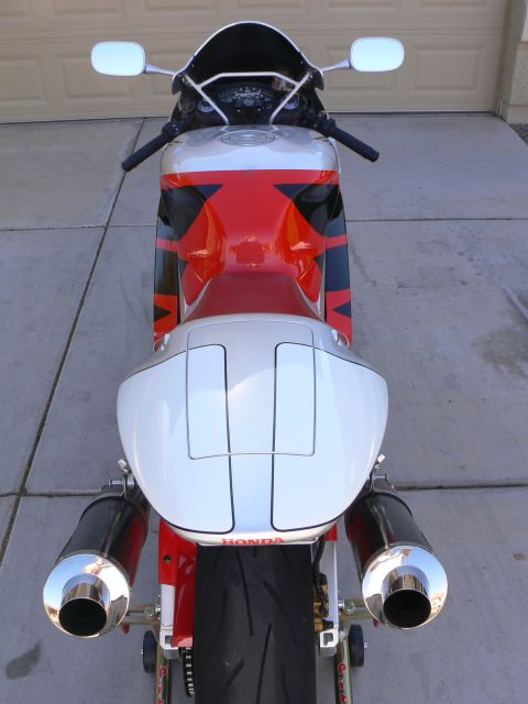 1978 Ford Bronco - This motorcycle features a distinctive red, white, and black paint scheme with dual exhaust pipes visible from the rear.