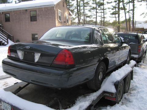 1991 Ford Crown Victoria LTD - A dark 1991 Ford Crown Victoria LTD is seen being transported on a trailer during winter.