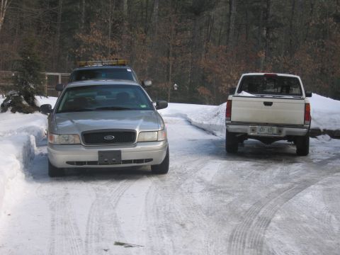 1991 Ford LTD Crown Victoria - A silver sedan is parked in a snowy driveway, with another vehicle visible behind it.