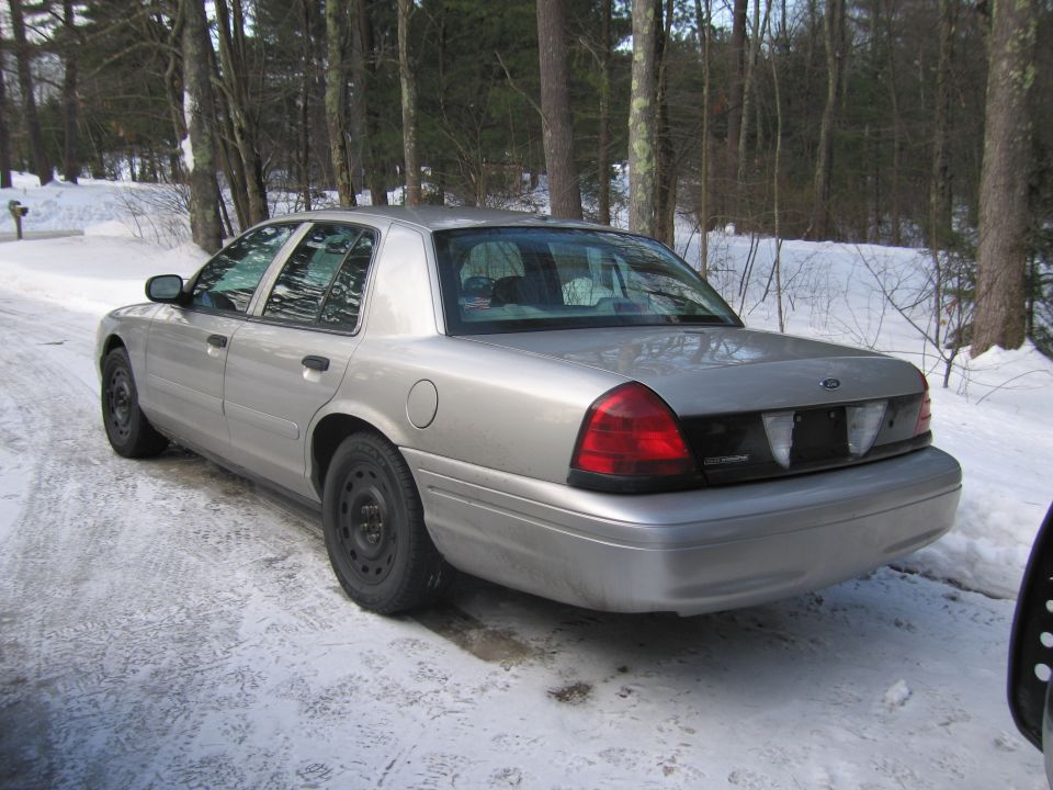 Silver Ford Crown Victoria parked on a snowy driveway