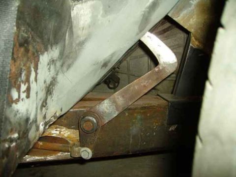 1969 MINI Cooper - Close-up view of a rusted metal linkage and frame, likely part of a vehicle undergoing restoration.