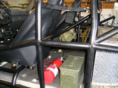 1986 Toyota Hilux - Interior view of a 1986 Toyota Hilux modified with a roll cage and racing seats.