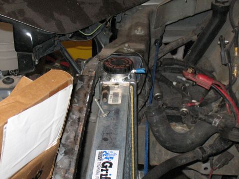 2001 Pontiac Trans Am - Close-up view of a car's engine compartment, focusing on the radiator and associated plumbing and wiring.