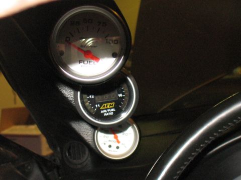 2001 Pontiac Trans Am - A close-up shot of the vehicle's interior dashboard shows three stacked gauges, including fuel level and air/fuel ratio.