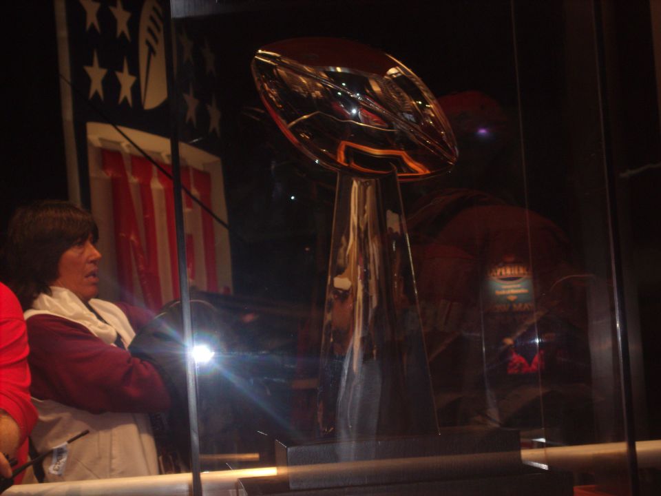 Trophy displayed behind glass with a person looking on