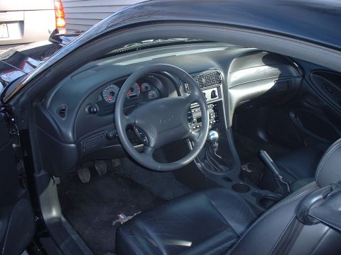 2002 Ford Mustang - Interior view of a 2002 Ford Mustang, the dashboard and driver's seat.