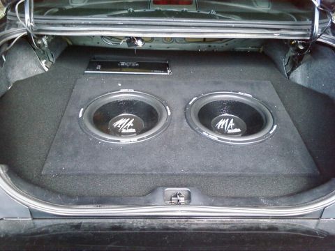 2000 Ford Crown Victoria - The trunk of a car is fitted with a custom enclosure housing two MA Audio subwoofers and an amplifier.