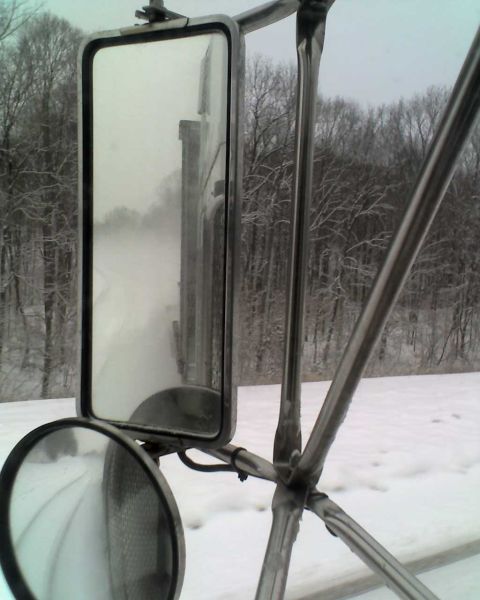 1995 Mercury Grand Marquis - View from inside a truck cab shows side mirrors reflecting a snow-covered landscape and road.
