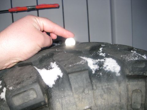 1990 Ford Bronco - Close-up of snow accumulation on a tire's tread pattern.