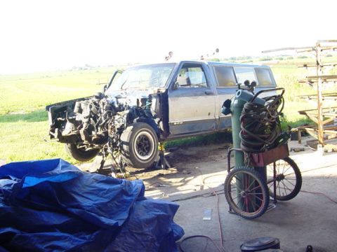 1992 Ford Bronco - This vehicle is in a state of disassembly, with its engine compartment open and parts removed.