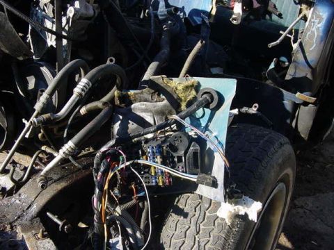 1992 Ford Bronco - Close-up of a vehicle's engine bay, showing complex wiring and plumbing.