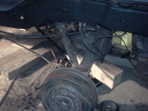 1996 Ford Bronco - Underside view of a vehicle's rear axle and suspension system, possibly undergoing maintenance.