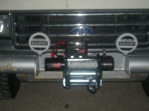 1991 Ford Bronco - The front of a Ford truck is shown, a grille and a winch installed on the bumper.