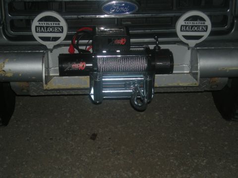 1991 Ford Bronco - Front view of a 1991 Ford Bronco, a winch and Navigator Halogen lights mounted on the bumper.