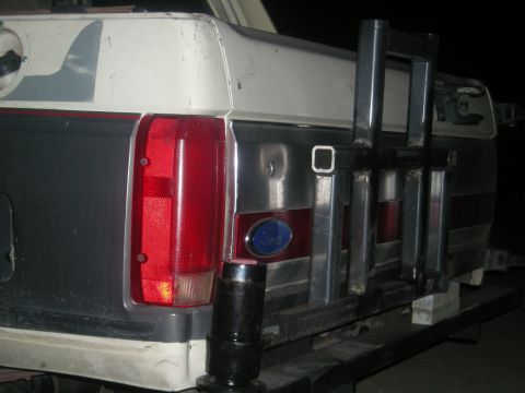 1991 Ford Bronco - The rear of a 1991 Ford Bronco shows its two-tone paint and a custom-mounted metal rack.