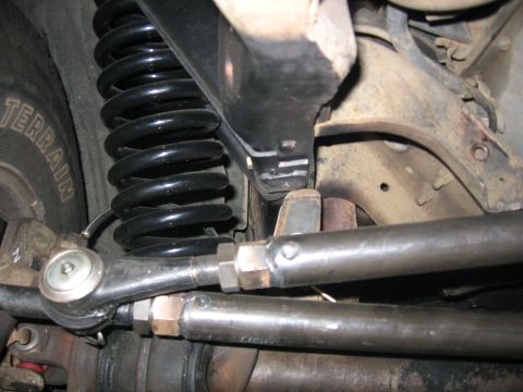 1989 Ford Bronco - Detailed view of vehicle suspension components, including a coil spring and steering linkage.