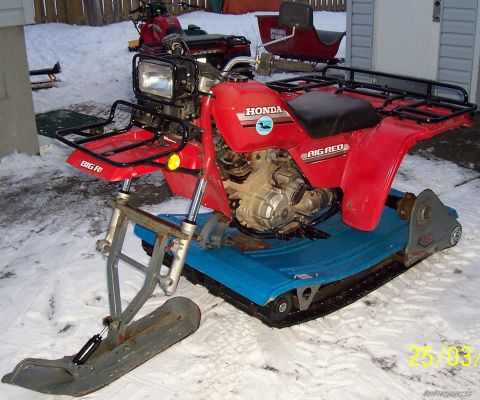 2000 Ford E350 - Red Honda ATC Big Red modified with a ski and track system for snow travel.