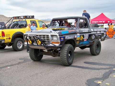 1994 Ford Bronco - This modified truck, likely from the late 1970s, is prepared for off-road racing with a prominent roll cage and sponsor graphics.
