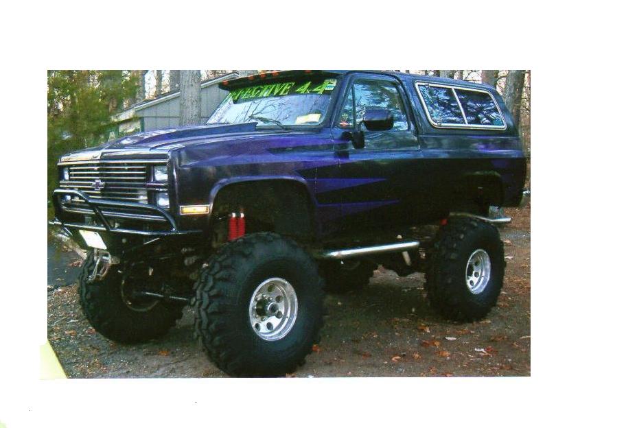 Lifted 1987 Chevrolet K5 Blazer with purple flame graphics and large off-road tires