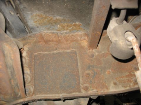 1995 Ford C-350 (Centurion Conversions) - Close-up view of heavily rusted vehicle frame components, showing signs of significant corrosion.
