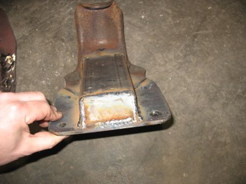 1995 Ford C-350 (Centurion Conversions) - Close-up of a rusty metal bracket that has been modified with new welds.