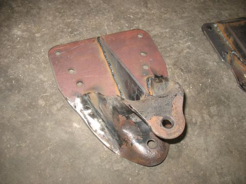 1995 Ford C-350 (Centurion Conversions) - A close-up view of a single, heavily used, metal rear spring hanger bracket.
