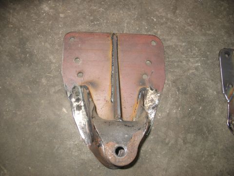 1995 Ford C-350 (Centurion Conversions) - A metal rear spring hanger part is shown, welds and a central bolt hole.