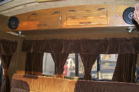 1982 Ford E350 - Looking out from the van's interior, past velvet curtains, reveals another vehicle in the background.