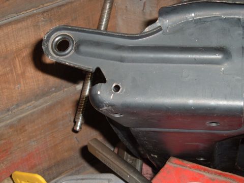 1990 Ford Ranger - A close-up view shows a black metal bracket with a circular hole and a threaded bolt passing through it. The bracket appears to be part of…