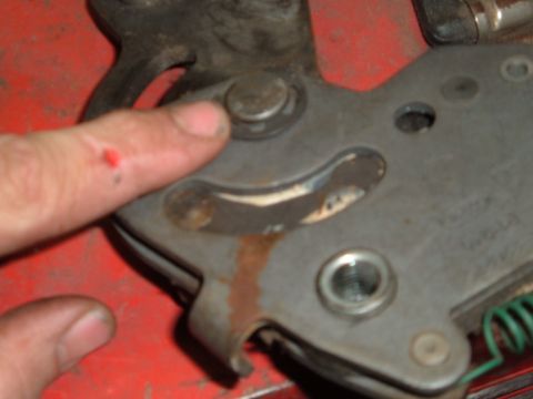 1990 Ford Ranger - A close-up view shows a person's finger with a small red mark on it, touching a metal mechanism that appears to be part of a tool or vehicl…
