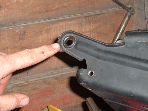 1990 Ford Ranger - A close-up shot shows a person's finger pointing to a black metal bracket with a rubber bushing. The bracket appears to be part of a larger…
